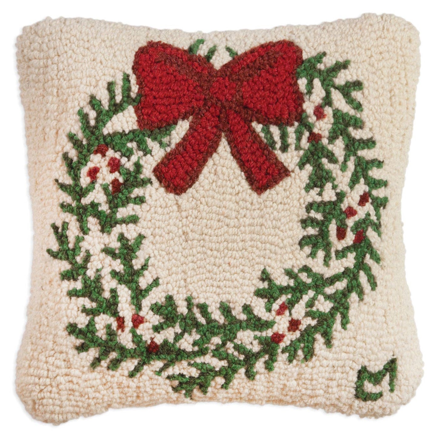 Decorative pillow with a Christmas wreath and red bow design on a beige background