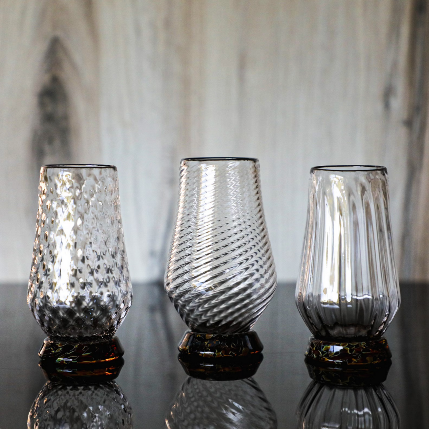 These exquisite glasses are hand-blown right here in the Pacific Northwest. Each of the three glasses is crafted using a unique mold, resulting in their distinct styles. Sold individually, you can assemble your own set.

The Hand-Blown Neat Pour Glass is meticulously crafted to amplify the aromatic notes of your selected spirit, ensuring an exquisite and immersive drinking experience. It is an ideal choice for a diverse range of beverages, including smooth scotch and aged tequila, as well as any other premi