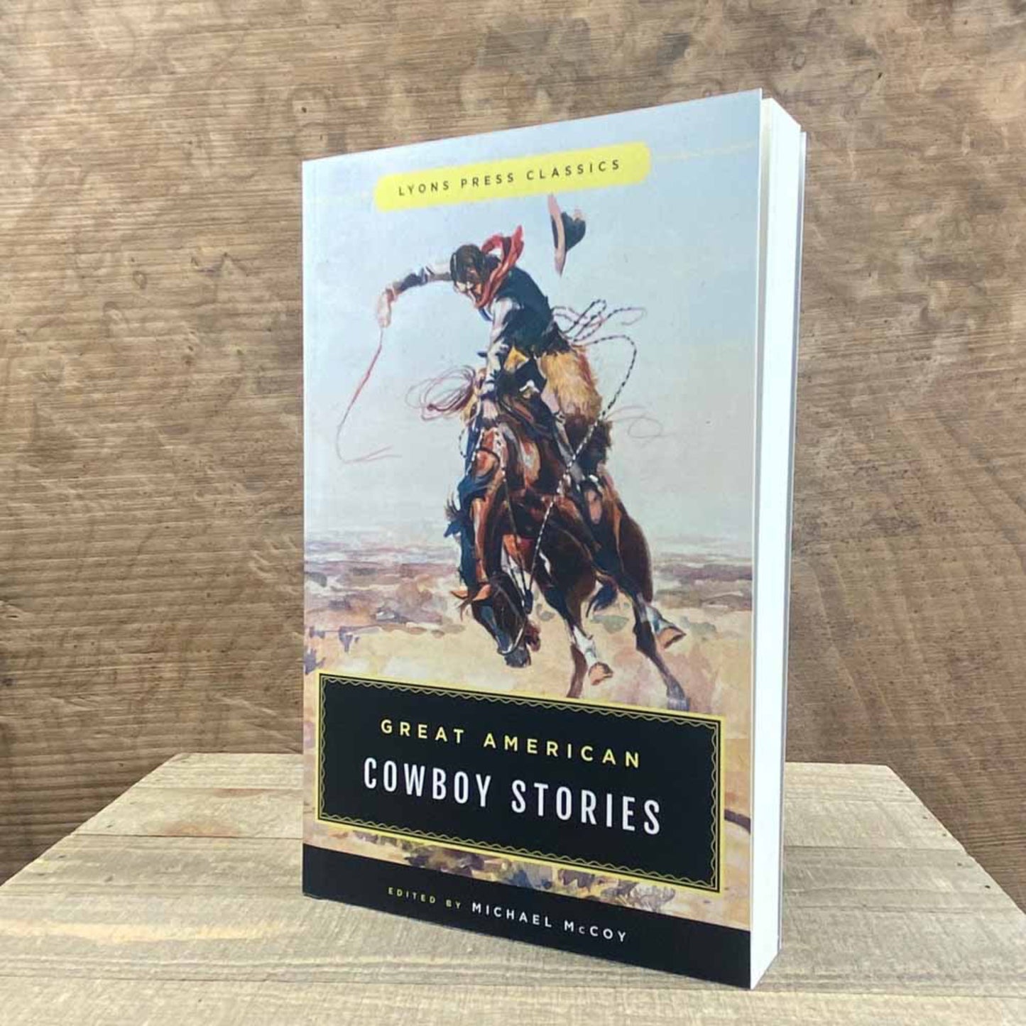 Book titled 'Great American Cowboy Stories' on a wooden surface