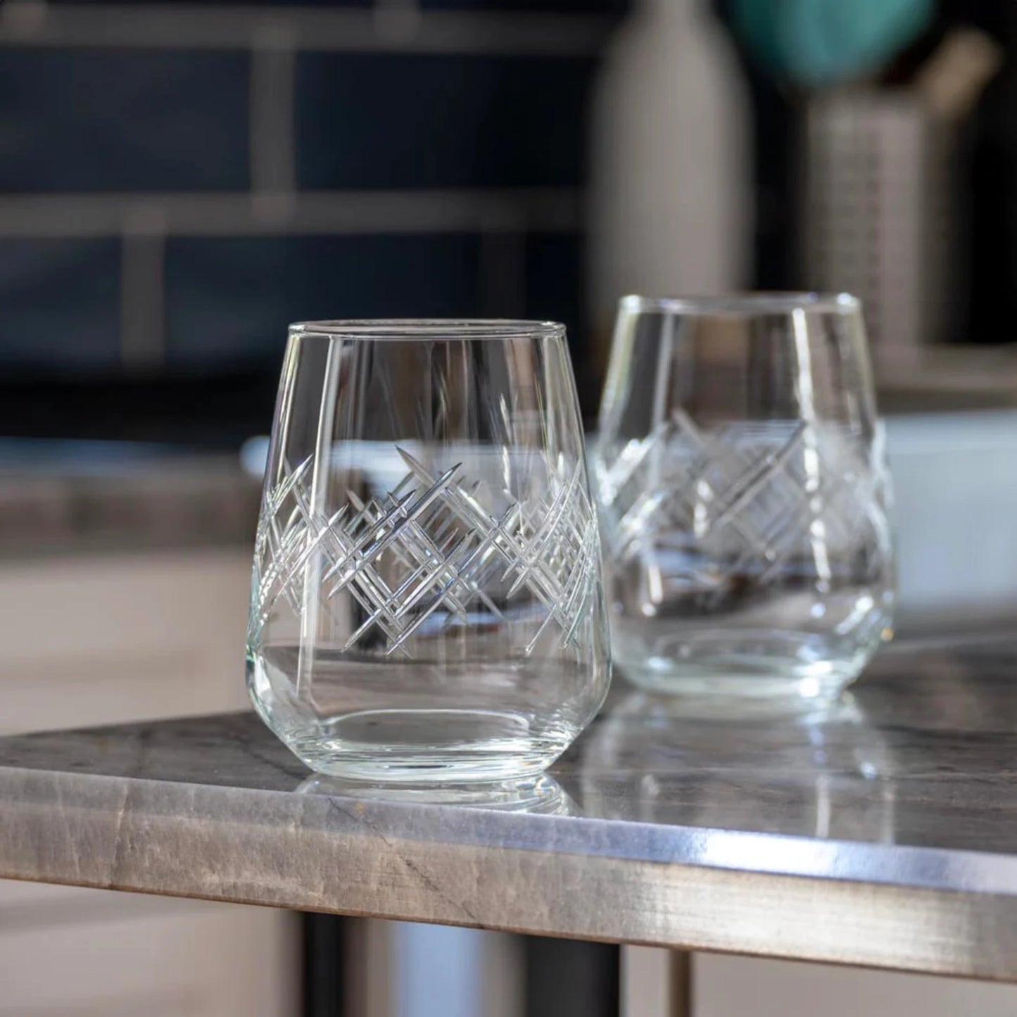 Experience the elegance of the Argyle 15.75oz Stemless Wine Glass, a timeless design inspired by the tartans of the Clan Cambell of Argyll, Scotland in the 17th century. This classic diamond pattern became an iconic symbol of British fashion after the Duke of Windsor adopted it in the 1920s. Crafted by Rolf Glass, each piece is a testament to the enduring appeal of the Argyle pattern. Elevate your wine tasting experience with this sophisticated and stylish wine glass.