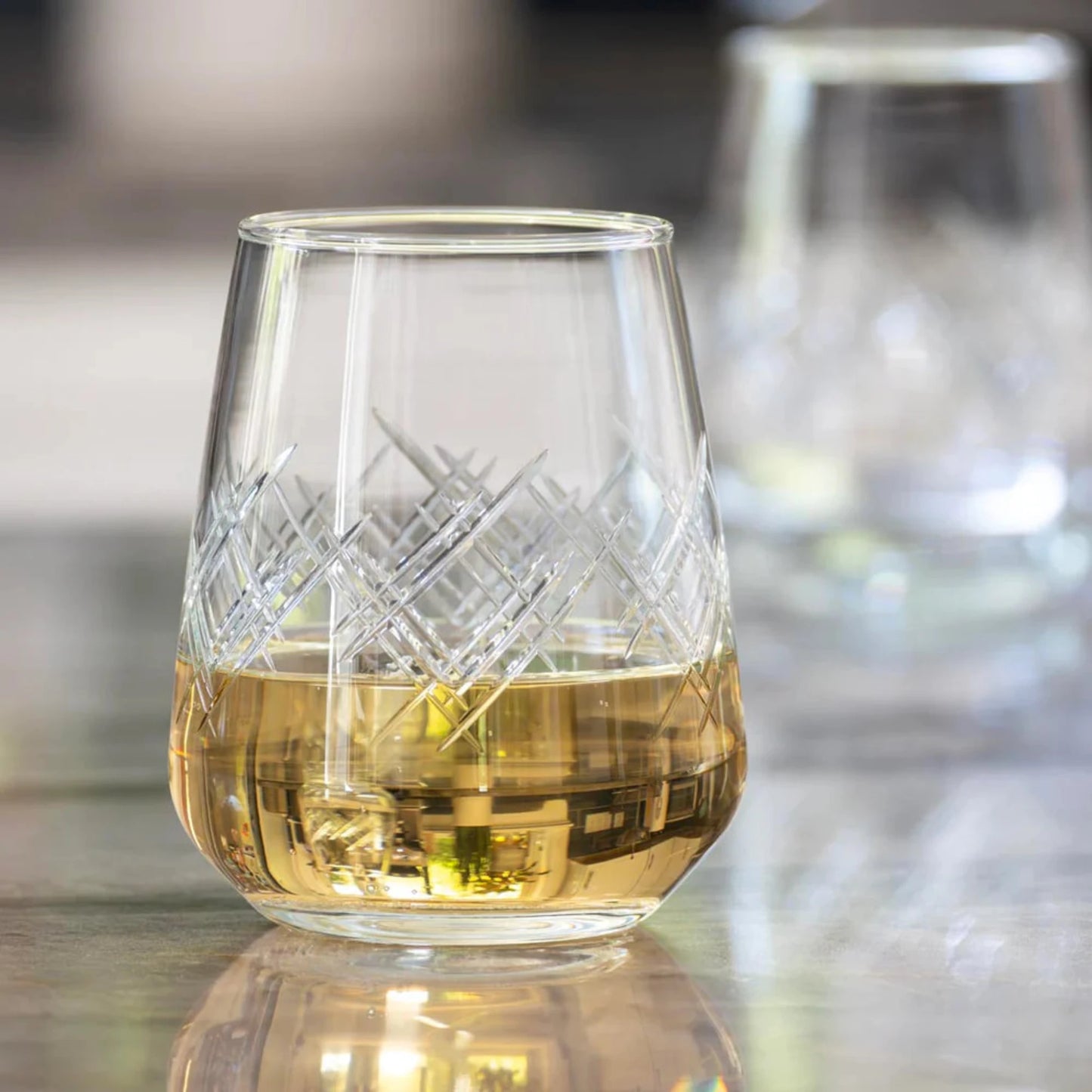 Experience the elegance of the Argyle 15.75oz Stemless Wine Glass, a timeless design inspired by the tartans of the Clan Cambell of Argyll, Scotland in the 17th century. This classic diamond pattern became an iconic symbol of British fashion after the Duke of Windsor adopted it in the 1920s. Crafted by Rolf Glass, each piece is a testament to the enduring appeal of the Argyle pattern. Elevate your wine tasting experience with this sophisticated and stylish wine glass.