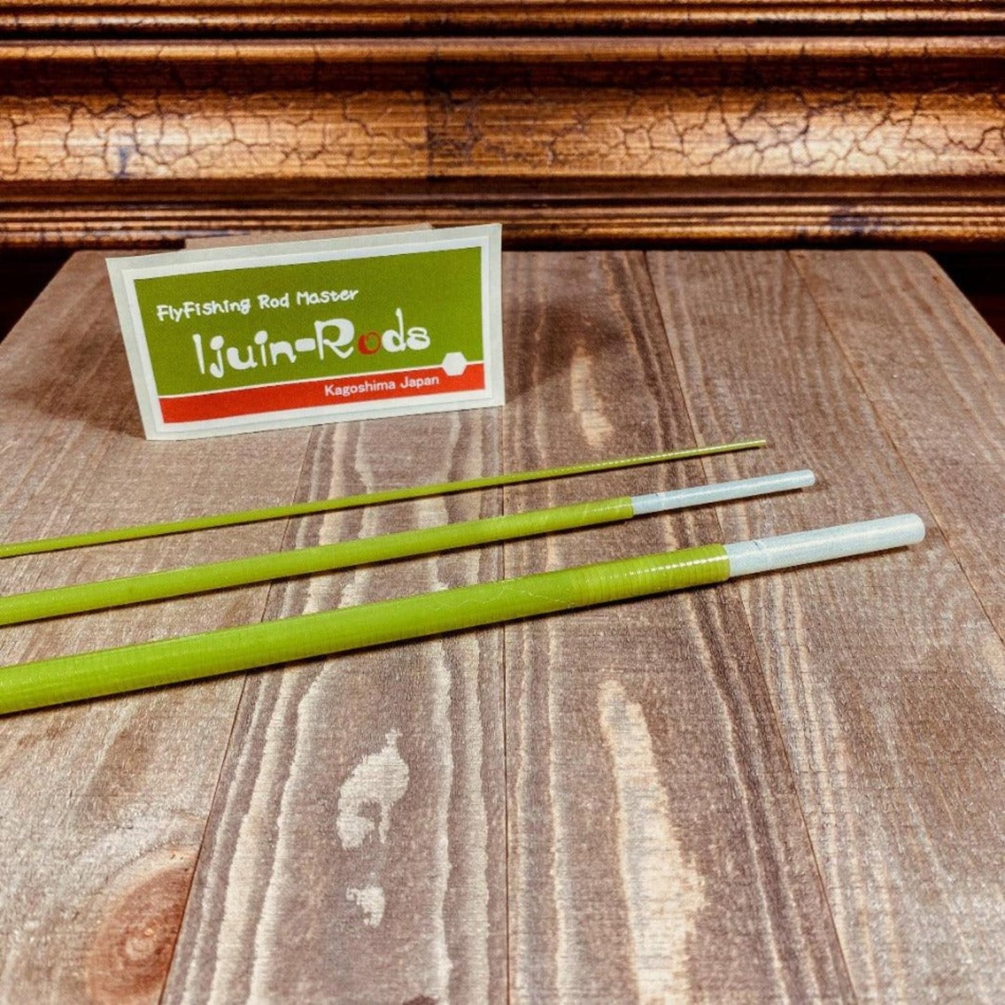 Three-piece fly fishing rod blank set on a wooden surface, with the product packaging visible in the background.