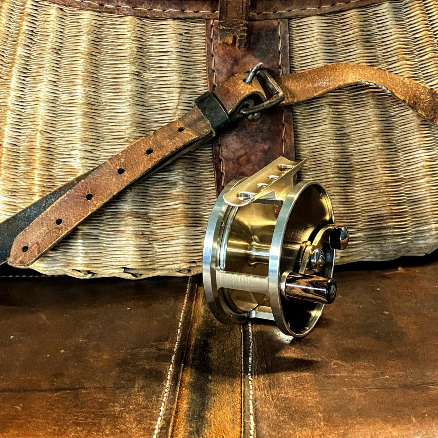 Nikko Cobblestone Small Trout reel with premium packaging - black box, handwritten label, and leather pouch included