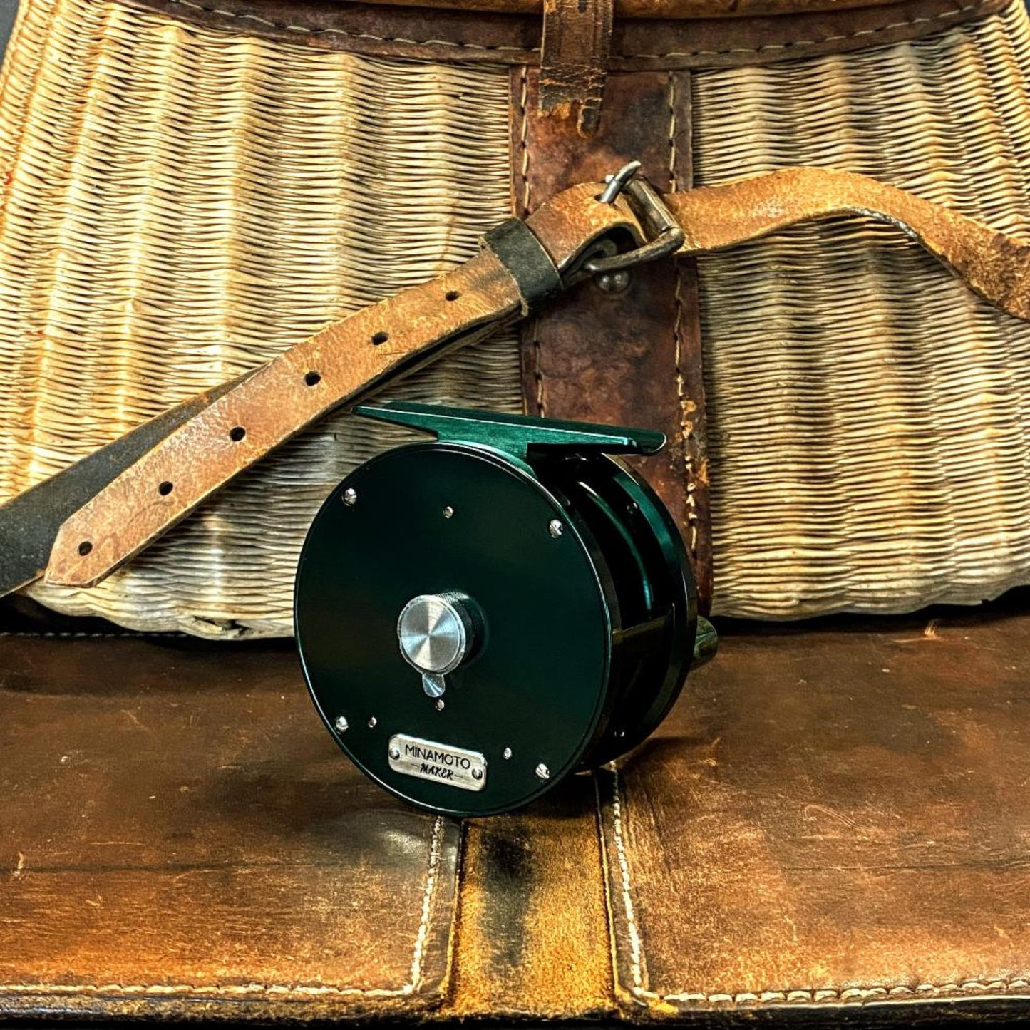 Nikko Leaf Small Trout fly reel with green backing plate and hand-polished finish - front view