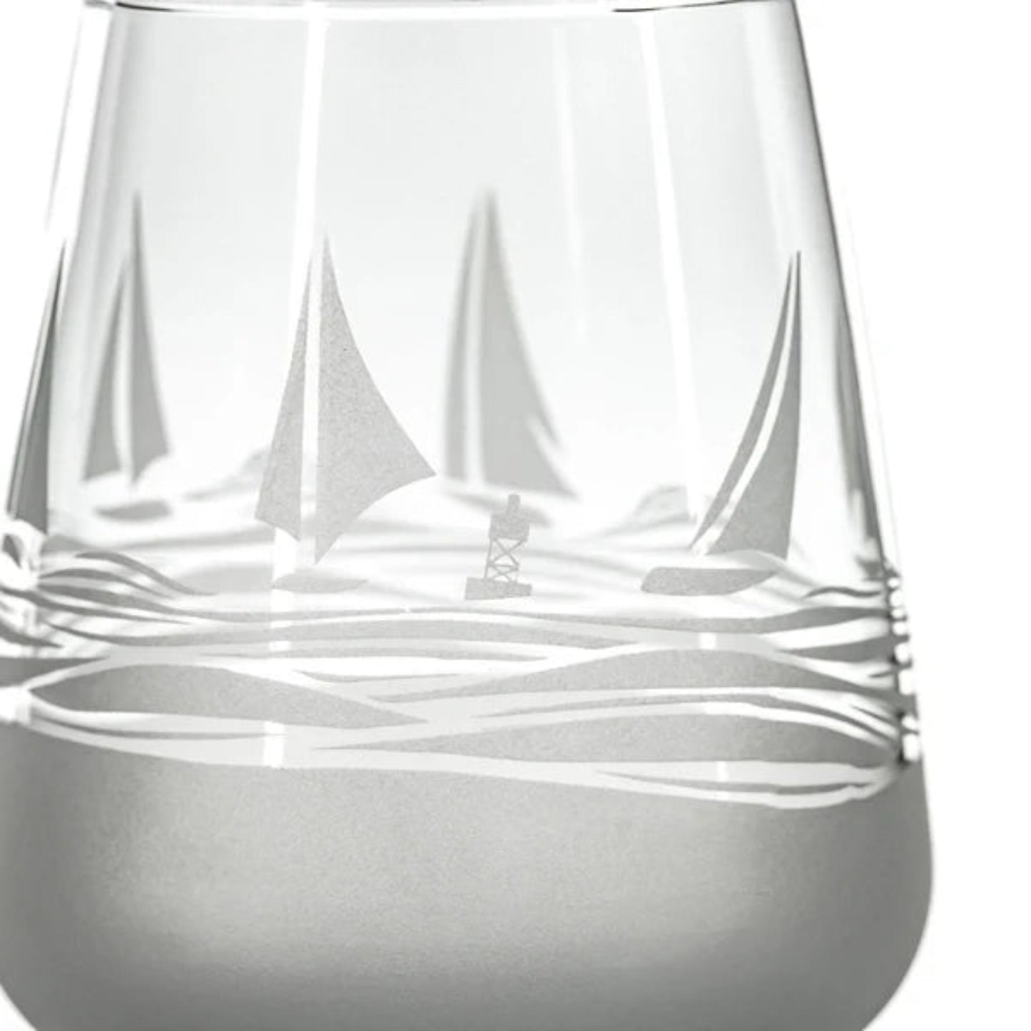 Experience the charm of the sea with every sip from our Regatta 15.75oz Stemless Wine Glass. This beautifully crafted glass features a sand-etched design of stylized sailboats, adding a touch of nautical elegance to your wine tasting experience. The stemless design ensures a comfortable grip, while the deep bowl allows you to appreciate the aroma of your favorite wines. Perfect for wine enthusiasts and nautical aficionados alike.